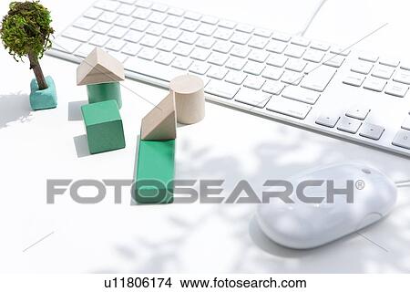 Picture - Wooden houses, computer keyboard and mouse on white background. Fotosearch
