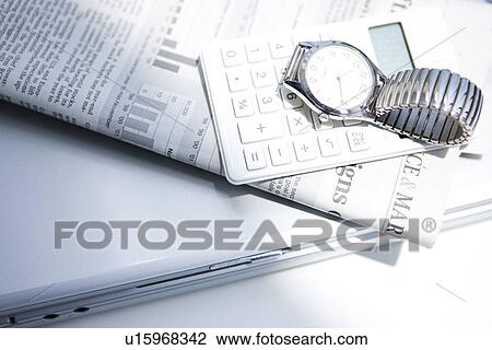 Wristwatch, calculator and newspaper on laptop, close up, white background View Large Photo Image Stock Image - Wristwatch, calculator and newspaper on laptop, close up, white background. Fotosearch