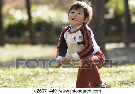 Stock Photo - Young boy holding a leaf. Fotosearch