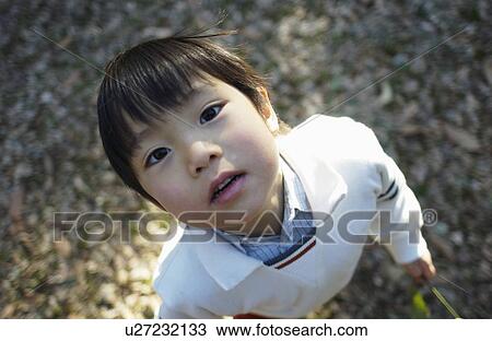 Young boy looking up, high angle view View Large Photo Image Stock Image - Young boy looking up, high angle view. Fotosearch
