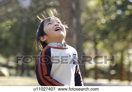 Young boy looking up View Large Photo Image Stock Photo - Young boy looking up. Fotosearch