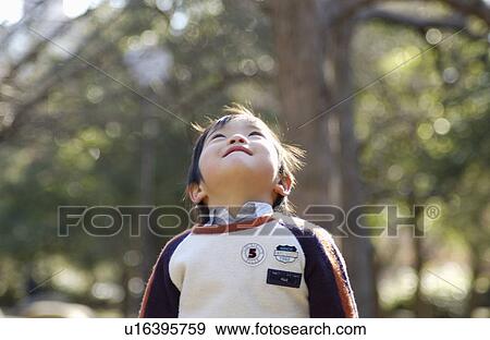 Stock Photo - Young boy looking up. Fotosearch