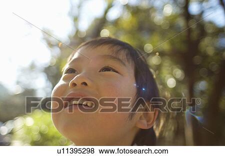 Stock Photo - Young boy, low angle view. Fotosearch