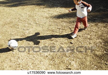 Young boy playing soccer, Tokyo Prefecture, Honshu, Japan View Large Photo Image Stock Image - Young boy playing soccer, Tokyo Prefecture, Honshu, Japan. Fotosearch