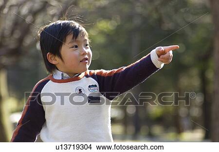 Picture - Young boy pointing. Fotosearch