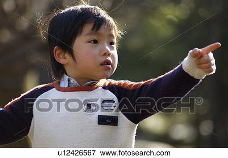 Young boy pointing View Large Photo Image Stock Photo - Young boy pointing. Fotosearch
