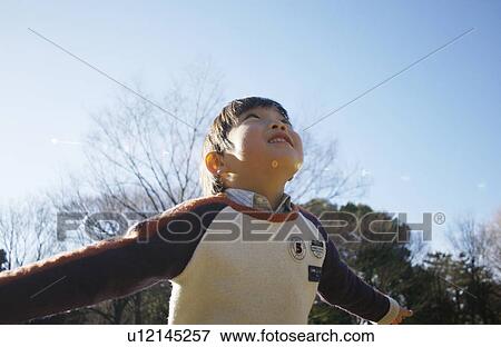 Young boy pretending to fly View Large Photo Image Stock Photo - Young boy pretending to fly. Fotosearch