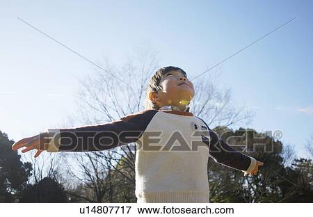 Young boy pretending to fly View Large Photo Image Stock Photo - Young boy pretending to fly. Fotosearch