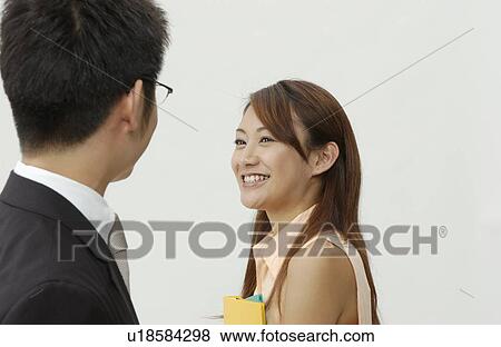 Young Business Man and Woman Smiling to Each Other View Large Photo Image Stock Photo - Young Business Man and Woman Smiling to Each Other. Fotosearch