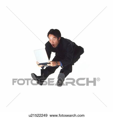 Young businessman jumping with laptop View Large Photo Image Stock Photo - Young businessman jumping with laptop. Fotosearch