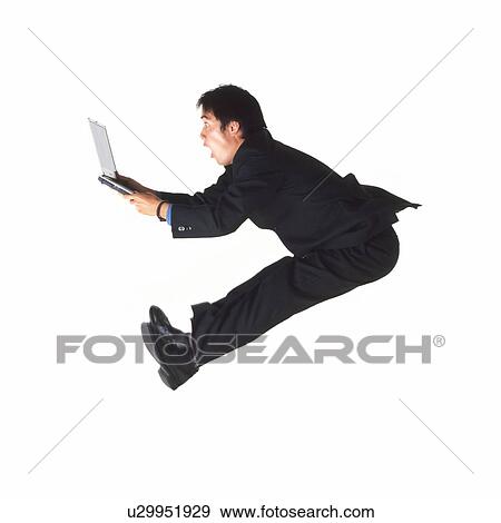 Stock Photo - Young businessman jumping with laptop. Fotosearch