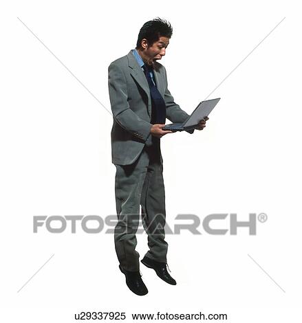 Young businessman jumping with laptop View Large Photo Image Stock Photography - Young businessman jumping with laptop. Fotosearch