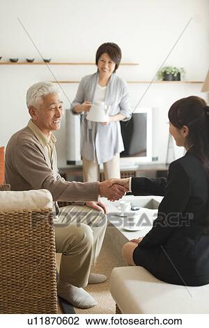 Young businesswoman and senior man shaking hands, smiling View Large Photo Image Stock Image - Young businesswoman and senior man shaking hands, smiling. Fotosearch