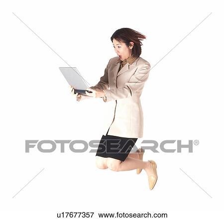Young businesswoman jumping with laptop View Large Photo Image Stock Photo - Young businesswoman jumping with laptop. Fotosearch