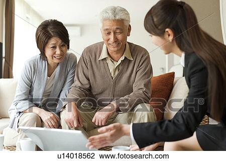 Young businesswoman showing computer monitor to senior couple View Large Photo Image Stock Image - Young businesswoman showing computer monitor to senior couple. Fotosearch