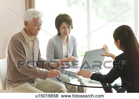 Young businesswoman showing computer monitor to senior couple View Large Photo Image Stock Photo - Young businesswoman showing computer monitor to senior couple. Fotosearch
