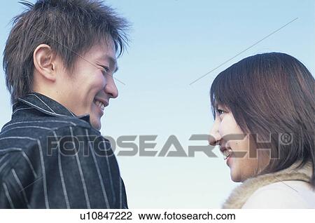 Stock Image - Young couple face to face. Fotosearch