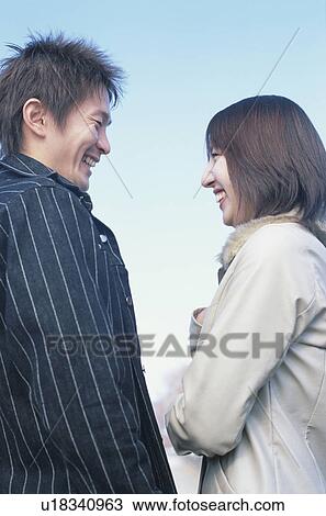 Stock Image - Young couple face to face. Fotosearch
