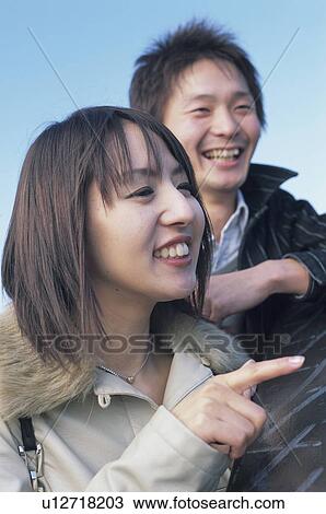 Young couple looking away View Large Photo Image Stock Image - Young couple looking away. Fotosearch