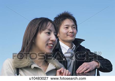 Stock Photo - Young couple looking away. Fotosearch