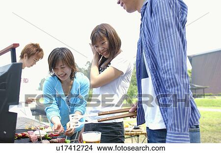 Picture - Young People Doing BBQ. Fotosearch