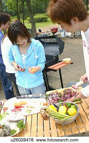 Young People Doing BBQ View Large Photo Image Stock Photo - Young People Doing BBQ. Fotosearch
