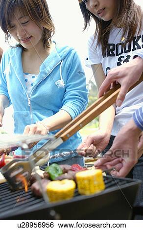 Stock Photograph - Young People Doing BBQ. Fotosearch