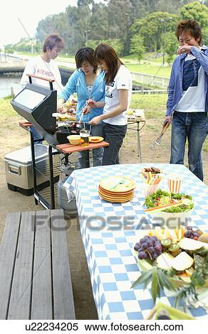 Stock Photography - Young People Doing BBQ. Fotosearch