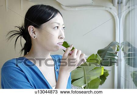 Young woman brushing teeth View Large Photo Image Stock Image - Young woman brushing teeth. Fotosearch
