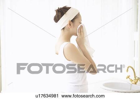 Young woman drying face View Large Photo Image Stock Image - Young woman drying face. Fotosearch
