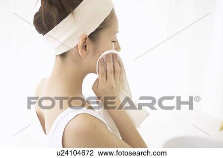 Young woman drying face View Large Photo Image Stock Image - Young woman drying face. Fotosearch