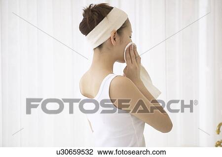 Young woman drying face View Large Photo Image Stock Image - Young woman drying face. Fotosearch