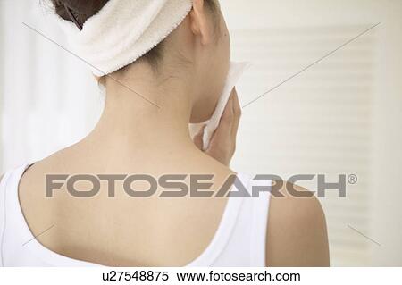 Stock Photography - Young woman drying face. Fotosearch