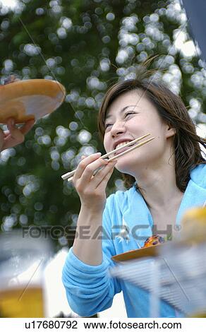 Young woman eating barbecue, Tokyo Prefecture, Honshu, Japan View Large Photo Image Stock Image - Young woman eating barbecue, Tokyo Prefecture, Honshu, Japan. Fotosearch