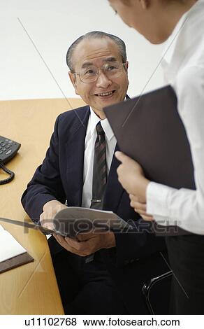Young Woman Executive Assistant and Her Boss at Office View Large Photo Image Stock Photo - Young Woman Executive Assistant and Her Boss at Office. Fotosearch