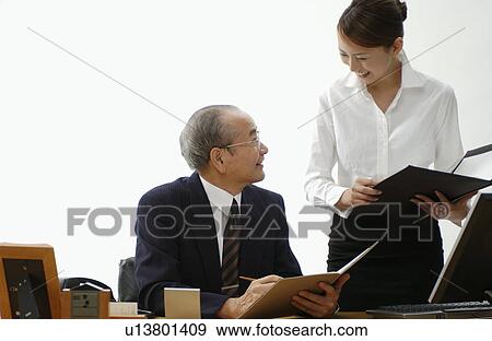 Young Woman Executive Assistant and Her Boss at Office View Large Photo Image Stock Photo - Young Woman Executive Assistant and Her Boss at Office. Fotosearch