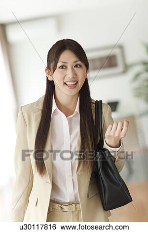 Young woman holding bag on shoulder, smiling View Large Photo Image Stock Photograph - Young woman holding bag on shoulder, smiling. Fotosearch