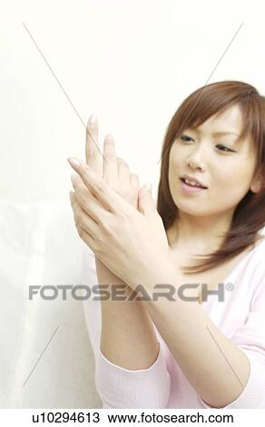Young woman massaging hand View Large Photo Image Stock Image - Young woman massaging hand . Fotosearch