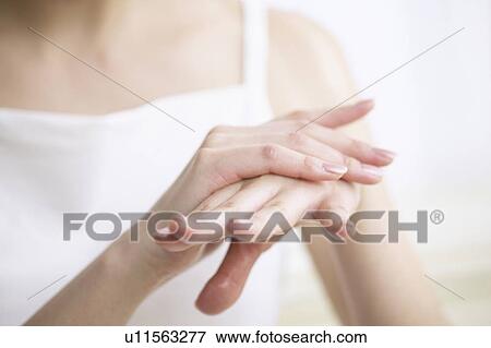 Young woman massaging hands, close up View Large Photo Image Stock Photo - Young woman massaging hands, close up. Fotosearch