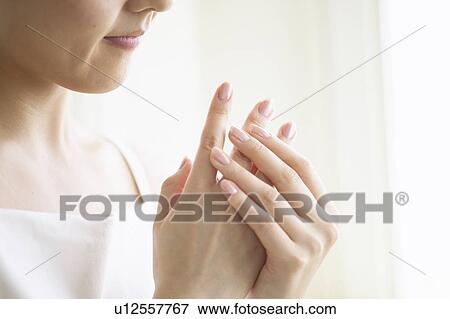 Young woman massaging hands, close up View Large Photo Image Stock Photo - Young woman massaging hands, close up. Fotosearch