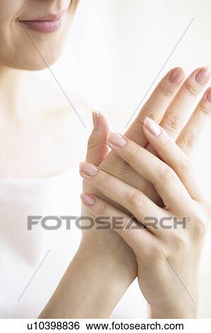 Young woman massaging hands, close up View Large Photo Image Stock Photograph - Young woman massaging hands, close up. Fotosearch