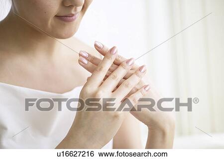 Young woman massaging hands, close up View Large Photo Image Stock Photograph - Young woman massaging hands, close up. Fotosearch