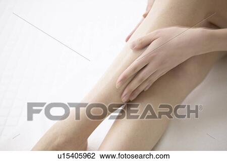 Young woman massaging legs in bathroom, close up View Large Photo Image Stock Image - Young woman massaging legs in bathroom, close up. Fotosearch