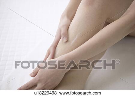 Young woman massaging legs in bathroom, close up View Large Photo Image Stock Photo - Young woman massaging legs in bathroom, close up. Fotosearch