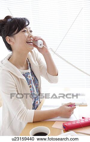 Stock Image - Young woman on a telephone. Fotosearch