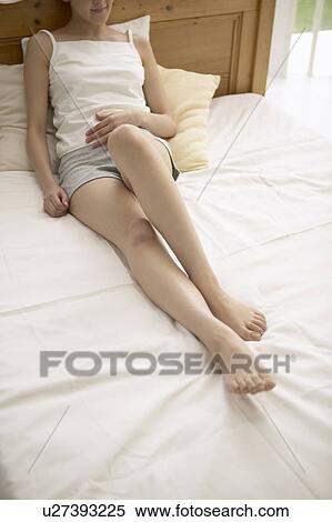 Young woman on bed View Large Photo Image Stock Photography - Young woman on bed. Fotosearch