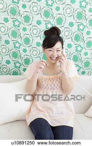 Young woman on telephone View Large Photo Image Stock Image - Young woman on telephone. Fotosearch