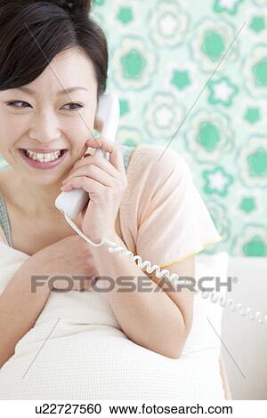Young woman on telephone View Large Photo Image Stock Image - Young woman on telephone. Fotosearch