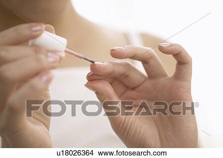 Young woman polishing nails, close up View Large Photo Image Picture - Young woman polishing nails, close up. Fotosearch