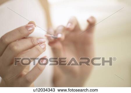 Young woman polishing nails, close up View Large Photo Image Stock Image - Young woman polishing nails, close up. Fotosearch